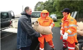  ?? Photograph: Jason O’Brien/AAP ?? State Emergency Services members prepare for flooding in the northern NSW town of Lismore on Sunday. Moderate flooding is forecast along the Wilsons River from late Monday morning, with major flooding possible from Monday night.