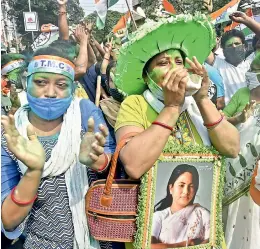  ?? PTI ?? TMC activists celebrate winning trend in the West Bengal state Assembly elections, in Kolkata on Sunday. —