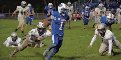  ?? KARL MERTON FERRON/BALTIMORE SUN ?? North East's Jalen Giles escapes the grasp of Patterson Mill’s Christian Cross to score a touchdown during the Ravens RISE Showdown.