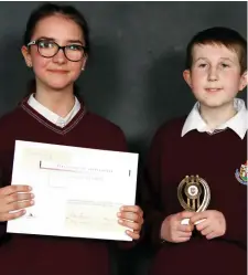  ??  ?? Adam O’Leary and Klaudia Teter receiving a Citizenshi­p award on behalf of their class for their charitable work during the Year at the St. Oliver’s Community College Awards night.