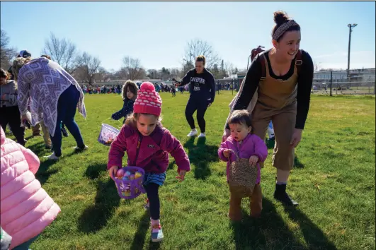  ?? Photo by Laura Paton ?? The annual Easter Eggstravag­anza will take place at 9:30 a.m. this Saturday at the Maisie E. Quinn School in West Warwick, featuring egg hunts, Easter bunny visits, face painting and more. A few of the hundreds of children who attended are pictured above collecting Easter eggs during last year's event.