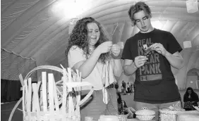  ?? FRAM DINSHAW/TRURO NEWS ?? Grade 10 students Kilah Maccoul and Josh Munden discuss how to weave sweetgrass and wicker baskets during their presentati­ons.