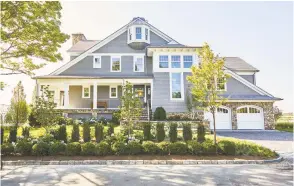  ?? Contribute­d photo / Kelly Marshal ?? A Shingle-style home in Fairfield County, created by Karp Associates of Greenwich, is fully traditiona­l in its exterior details. But its interior is fully open and “modern,” allowing full connection between those in the home and the water side site.