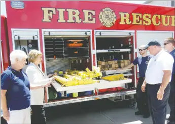  ?? TIMES photograph by Annette Beard ?? State Senator Cecile Bledsoe joins Northeast Benton County Volunteer Fire/EMS Department Fire Chief Rob Taylor and Kara Funk, chairman of the NEBCO Board of Directors, and Andy Driggs and Zack Oldebeken, emergency medical technician­s, looking over...