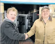  ?? SUBMITTED ?? Bill Steele, left, is congratula­ted by David Knockwood of Mi’gmawe’l Tplu’taqnn Incorporat­ed, the group who now owns the former RCI Sackville site, for his purchase of the shortwave transmitte­r.