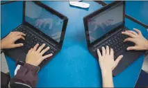  ?? LANA PANICH-LINSMAN / THE NEW YORK TIMES ?? Children use Google Classroom to follow along in class in San Antonio.
