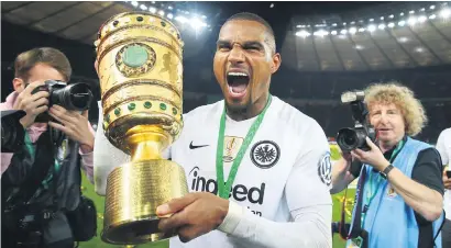  ?? Picture: Reuters ?? FRUITS OF VICTORY. Eintracht Frankfurt’s Kevin-Prince Boateng shows off the trophy after beating Bayern Munich to claim the German Cup at the Olympiasta­dion in Berlin on Saturday.