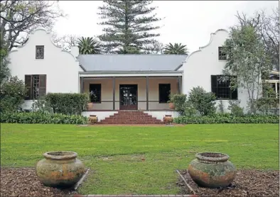  ??  ?? Left: The historic manor house at Constantia Uitsig. Below: The restaurant at Constantia Uitsig and, far left, the view from the restaurant.