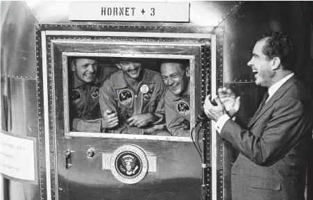  ?? MPI / Getty Images ?? President Richard Nixon greets astronauts Neil Armstrong, from left, Michael Collins and Buzz Aldrin on July 24, 1969, after their moon landing mission. They spent 65 hours in the Mobile Quarantine Facility on the Hornet, then were flown to Johnson Space Center.