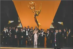  ?? The Associated Press ?? WINNERS: The cast and crew of "Game Of Thrones" accepts the award for outstandin­g drama series at the 71st Primetime Emmy Awards on Sunday at the Microsoft Theater in Los Angeles.