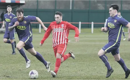  ??  ?? Seaham Red Star (red and white) battle against neighbours Ryhope CW in last month’s hard-fought derby at Seaham Town Park.