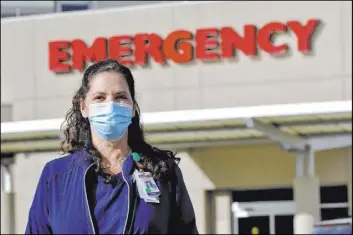  ?? Matt York The Associated Press ?? Caroline Maloney, seen Friday outside Scottsdale Osborn Medical Center in Scottsdale, Ariz., says that younger nurses are shaken by the virus deaths of younger patients but that she’s also seeing “amazing outcomes” and most of her ICU patients are recovering.