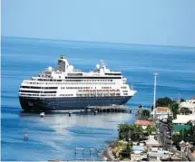  ?? HOLLAND AMERICA ?? Holland America’s intimate ship, the Maasdam, pictured docked at Dominica, offers primarily seven-day cruises between Montreal and Boston from May 24 through Oct. 11, 2014.
