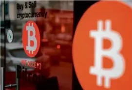  ?? DAVID LOMBEIDA/BLOOMBERG ?? Within a few minutes of hitting the record, bitcoin’s price dropped to about $67,500 and ended the day at $66,647.