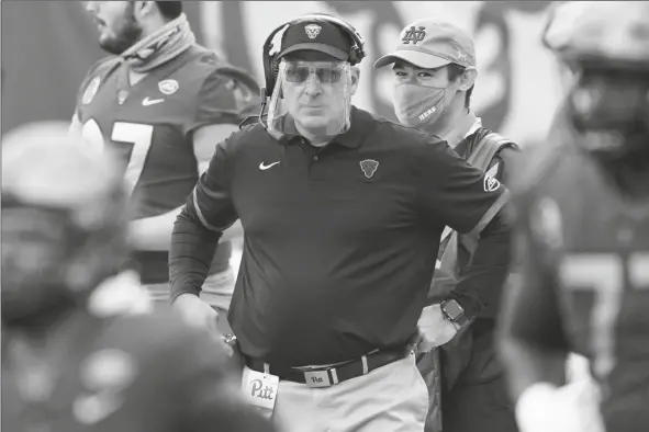  ?? ASSOCIATED PRESS ?? PITTSBURGH HEAD COACH PAT NARDUZZI wears a face shield as he watches his team play against Notre Dame during a game on Oct. 24 in Pittsburgh.