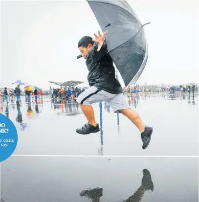  ??  ?? Fale Peivi, 7, of Hastings enjoys the rain during a netball tournament at the Hawke’s Bay Regional Sports Park. Photo / File