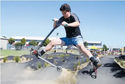  ?? Photos / Stuart Munro ?? Lochlan Watson, 14, pulls a scooter trick on the senior track at the official opening of the Whanganui Community Bike Park on Saturday.