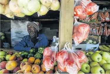  ?? Picture: DAVID HARRISON ?? FOOD CHAIN: Thabo Tseetse runs a spaza shop. He says: ‘I put the vegetables that are going off in a plastic bag and a truck takes it away. I don’t know what they do with it.’ Some spaza shops offer a discount instead of keeping stock