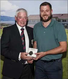  ??  ?? Dundalk GC President Noel McGuinness presents his prize to Aaron Waite on Sunday night.