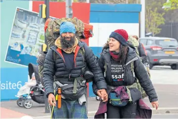  ??  ?? CHARITY EFFORT: Chris Lewis, with partner Kate, started his trip in Swansea in 2017.