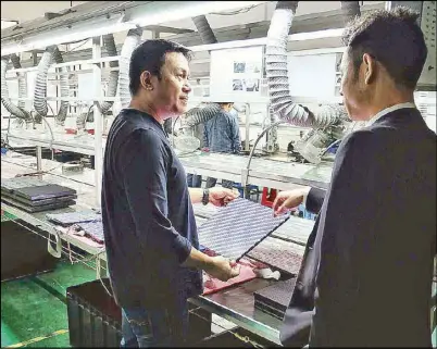  ??  ?? Hinolan at a factory in China where Audiowav’s proprietar­y devices are manufactur­ed.