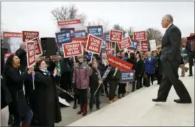  ?? JACQUELYN MARTIN — THE ASSOCIATED PRESS ?? Supporters of Illinois government employee Mark Janus cheer as he walks to thank them, outside the Supreme Court, Monday in Washington. The Supreme Court takes up a challenge Monday in a case that could deal a painful financial blow to organized labor....