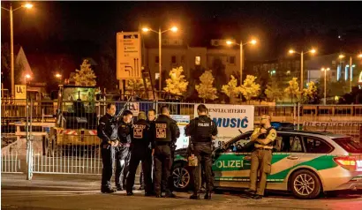  ?? AFP ?? policemen stand at the scene of the suicide attack in the southern German city of ansbach on monday. a syrian asylum-seeker set off an explosion at a bar in southern Germany that killed himself and wounded a dozen others, authoritie­s said. —