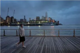  ??  ?? A young man wears a face mask as he walks on Pier 45 in Hudson River Park in New York in April. Photograph: Mark Lennihan/AP