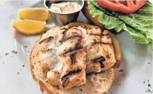  ?? ?? A grilled grouper sandwich with a side of corn salad at Harry’s Restaurant on Longboat Key
WADE TATANGELO PHOTOS/SARASOTA HERALD-TRIBUNE