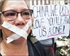  ?? TED ALJIBE/AFP ?? An anti-China protester attends a demonstrat­ion in front of the Chinese consulate in Manila on March 24. President Duterte has overseen $24 billion in trade deals with China since taking office, but some Filippinos are wary of their country’s links...