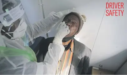  ?? Picture: AFP ?? A City of Tshwane health official takes a nasal swab to test for Covid-19 on a taxi operator at the Bloedstree­t Mall in the Pretoria central business district yesterday.