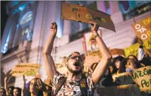  ?? Mauro Pimentel / AFP/Getty Images ?? Activists demonstrat­e during a protest against the government of Brazilian President Jair Bolsonaro over the fires in the Amazon rainforest, in Rio de Janeiro, Brazil on Friday.