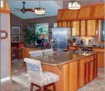  ??  ?? Kitchen amenities include custom cabinetry, granite counters and stainless-steel appliances.