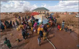  ?? ?? Water is distribute­d Sept. 20 at a camp for displaced people on the outskirts of Dollow.