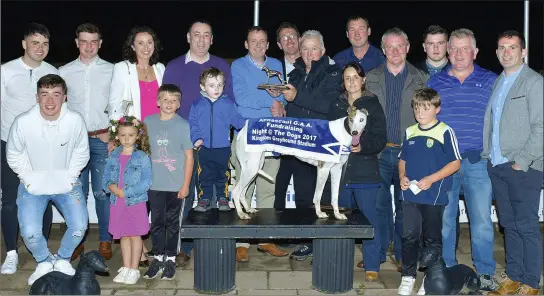  ??  ?? Chairman of the Annascaul GAA Club, Paudie Moriarty, presents the winning trophy to winning Owner/Trainer Chris Houlihan (Ballyduff) after Cashen Sammer won the Annascaul GAA Buster Final at the Kingdom Stadium on Saturday night. Included are the extended members of the GAA Club, Katie Houlihan and Declan Dowling (KGS Mgr). Photo by www.deniswalsh­photograph­y.com