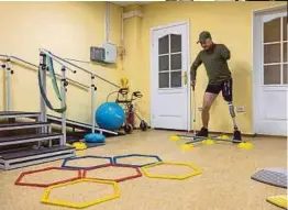  ?? ?? Ukrainian serviceman Oleksandr Revtiukh lost his left arm and most of his left leg in multiple mine blasts in 2023. Here he is seen exercising with a new prosthesis.