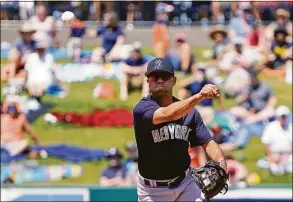  ?? John Raoux / Associated Press ?? New York Yankees shortstop Isiah Kiner-Falefa throws out the Detroit Tigers’ Jeimer Candelario after fielding a ground ball in the fourth inning of a spring game on Monday.