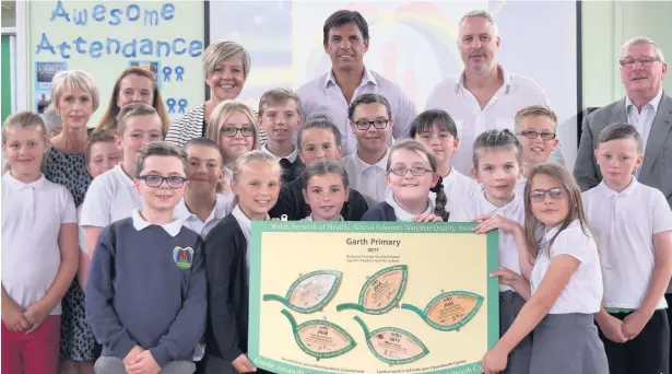  ??  ?? Wales football boss Chris Coleman with staff and pupils at Garth Primary School in Maesteg celebratin­g the National Quality Award from the Welsh Government