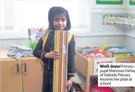  ??  ?? Well done Primary 2a pupil Mahnoor Farhan of Hallside Primary receives her prize at school