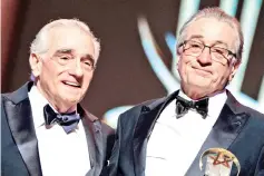  ??  ?? De Niro (above right and right) poses with a Tribute award, next to Director Scorsese during the 17th Marrakech Internatio­nal Film Festival on Saturday. — AFP photos