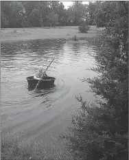  ?? COURTESY PHOTO ?? Mason Ryan Gray takes his horse trough boat for its maiden voyage on a flooded pond near Anderson as the wet weather continues.