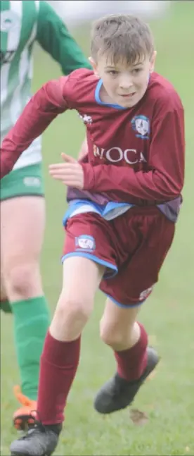  ??  ?? Ben McGorrian, St. Dominic’s and Ben Gorman, Shamrocks race for the ball during the U-15 League game in Fatima.