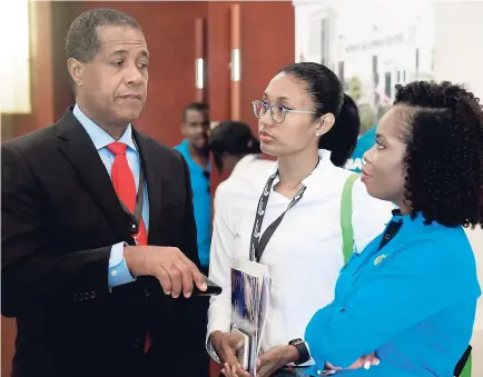  ??  ?? Lyttleton ‘Tanni’ Shirley (left), chairman of the Factories Corporatio­n of Jamaica, makes a point to members of his public-relations team, manager Dara Smith (right) and Paula King Gibson, public relations officer, during a break at the recently held...