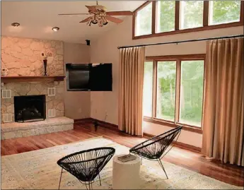  ??  ?? A granite-topped wet bar sits near the step down from the breakfast area into the family/hearth room, where tongue-and-groove Brazilian hardwood covers the floor in pleasing contrast to its natural stone fireplace.