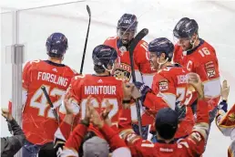  ?? DAVID SANTIAGO dsantiago@miamiheral­d.com ?? Carter Verhaeghe, second from right, is one of seven Panthers players who have scored at least 10 goals this season. The ‘Cardiac Cats’ are second in offensive production, averaging four goals per game, with a league-most 36.7 shots on goal per game.