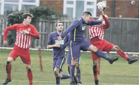  ??  ?? Ryhope CW (red and white) scrap it out with Guisboroug­h in last week’s 3-0 defeat. Pictures by Kevin Brady.