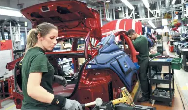  ?? BLOOMBERG ?? Employees work on a Jaguar automobile on the production line at Tata Motors Ltd’s Jaguar assembly plant in Castle Bromwich, United Kingdom.