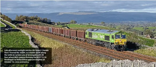  ?? STEVE SIENKIEWIC­Z ?? Late afternoon sunlight catches DB Cargo’s ‘Climate Hero’-liveried No. 66004, as it heads south along the Settle & Carlisle Line at Greengate with 40 four-wheel MEA wagons forming the 6E97/15.56 Newbiggin to Milford West gypsum empties on October 12.