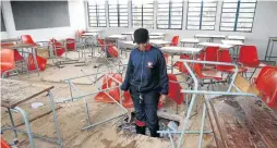  ??  ?? A grade 8 classroom at Rietvallei Extension 1 secondary school on the West Rand has a hole in the floor.