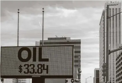  ?? Tim Fischer / Midland Reporter-Telegram ?? The price of oil is displayed in March outside several banks in Midland. Banks are pulling back at a time when troubled oil companies, especially those working in West Texas, need them most.